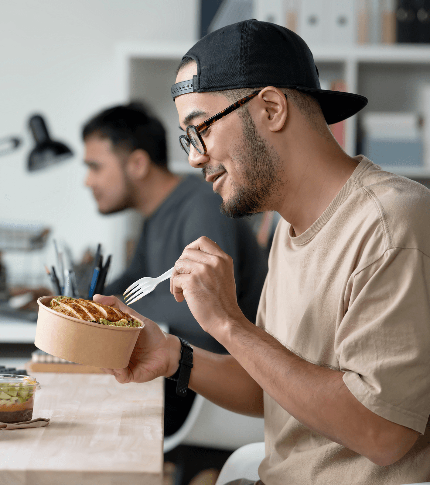 Man eating healthy food at work desk